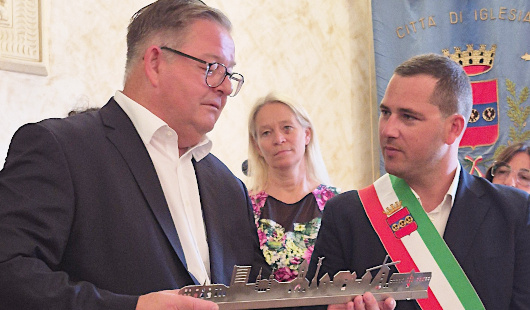 Bürgermeister Werner Nakot (li.) überreicht seinem Amtskollegen Mauro Usai eine stählerne Silhouette von Oberhausen. Foto: Stadt Oberhausen